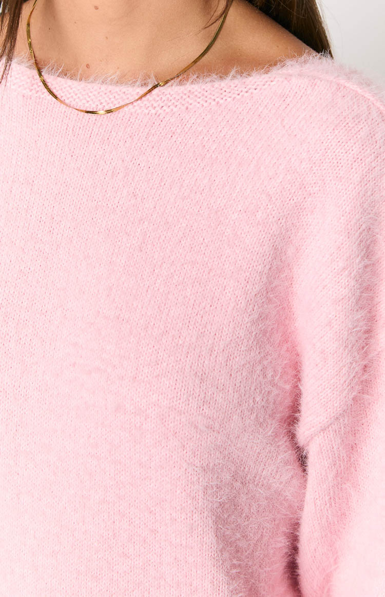 Close-up of the boat neckline and fluffy pink knit texture of the dress
