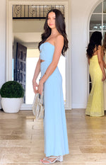 Side view of a light blue strapless maxi dress with a ruched bust and side cutout flowing to the floor