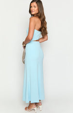 Side view of a light blue strapless maxi dress with a midriff cutout and a long, flowing skirt