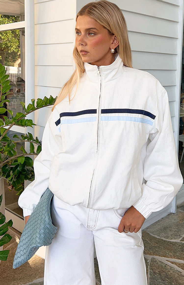 Cream funnel neck jacket with full zip closure and navy and light blue horizontal chest stripes