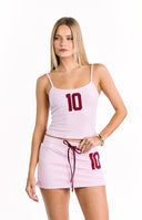 A sleeveless light pink tank top with thin spaghetti straps and a scoop neckline featuring a large dark red number 10 applique on the chest.