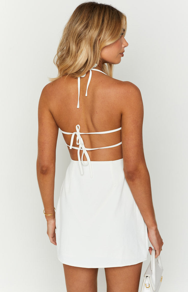 Rear view of a white mini dress showing the halter neck tie and multiple horizontal back ties