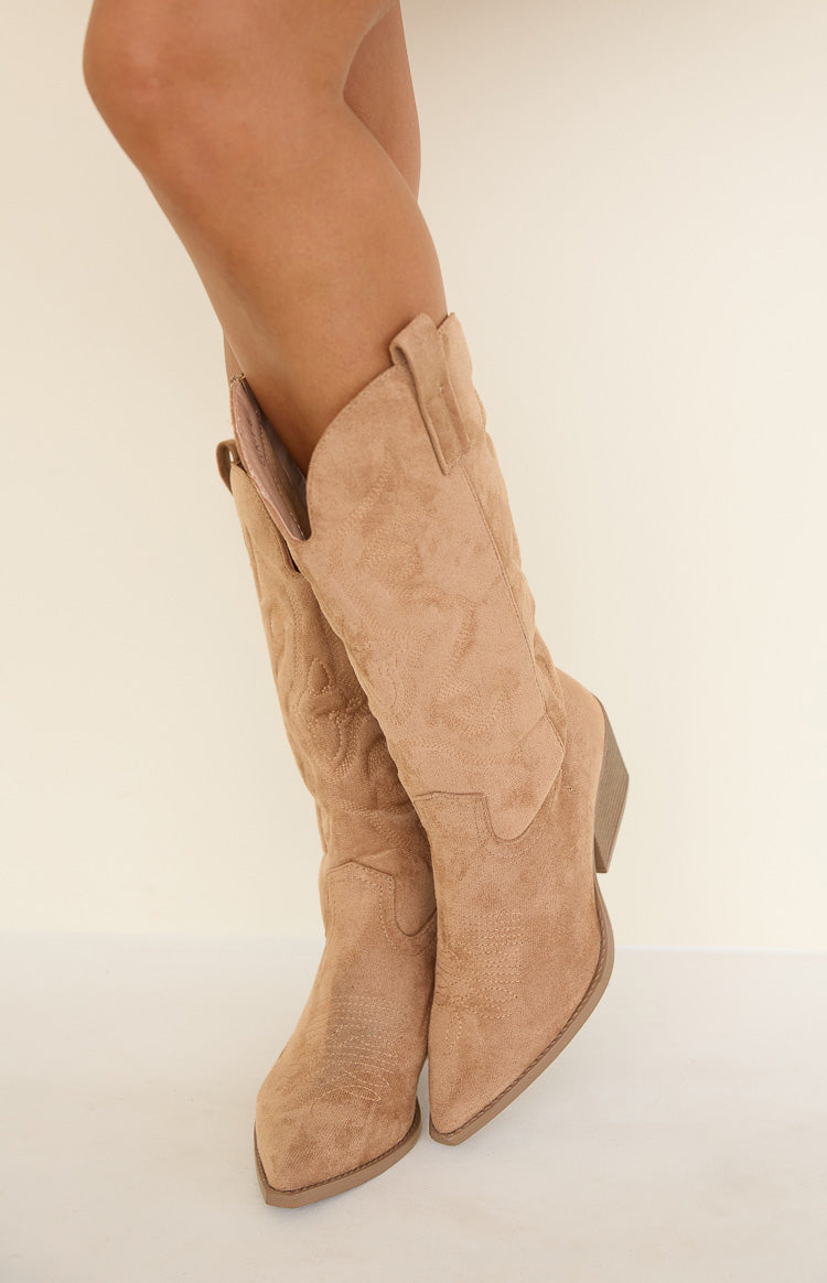 Camel suedette cowboy boots with classic western stitching on the shaft and pointed toe, showing the V-cut opening