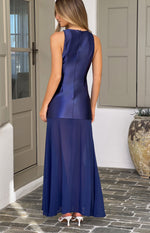 Rear view of a navy maxi dress with a fitted satin bodice and a flowy sheer chiffon skirt, showing the high back and zipper