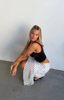 Beginning Boutique Khalea White Polka Dot Hanky Hem Midi Skirt white sheer polka dot midi skirt with a flowy hanky hem