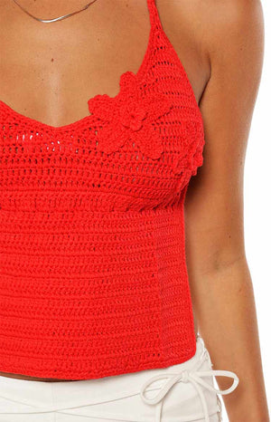 Model wears the Kiki Red Crochet Flower Halter Top a statement piece perfect for a summer festival or a beach party.