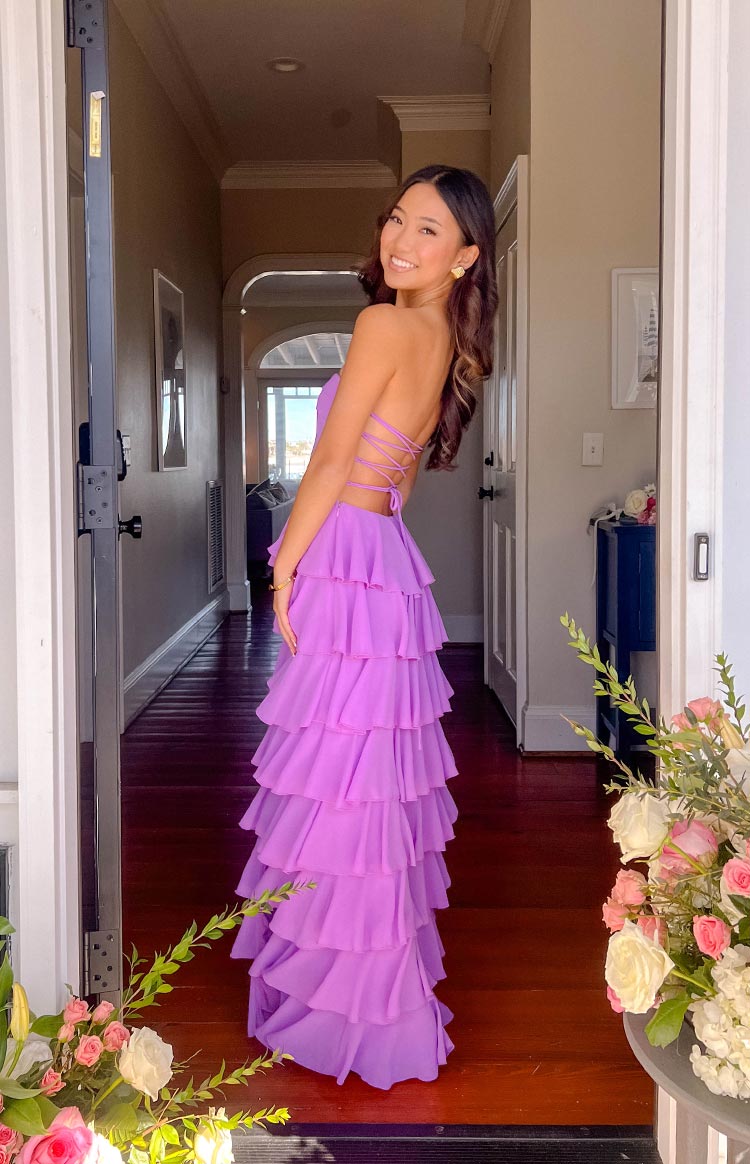 Side view of a lilac strapless maxi dress with a lace-up back and full tiered ruffle skirt