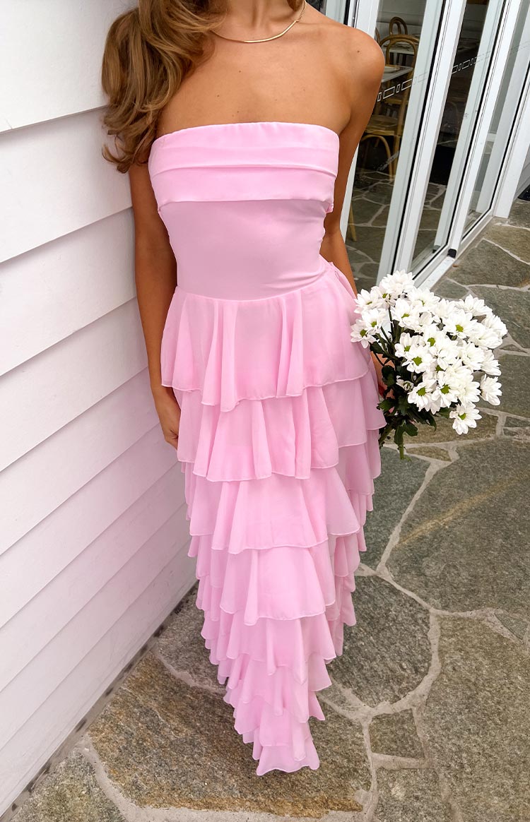 Rear view of a pink strapless maxi dress with a criss-cross lace-up back and a full tiered ruffle skirt