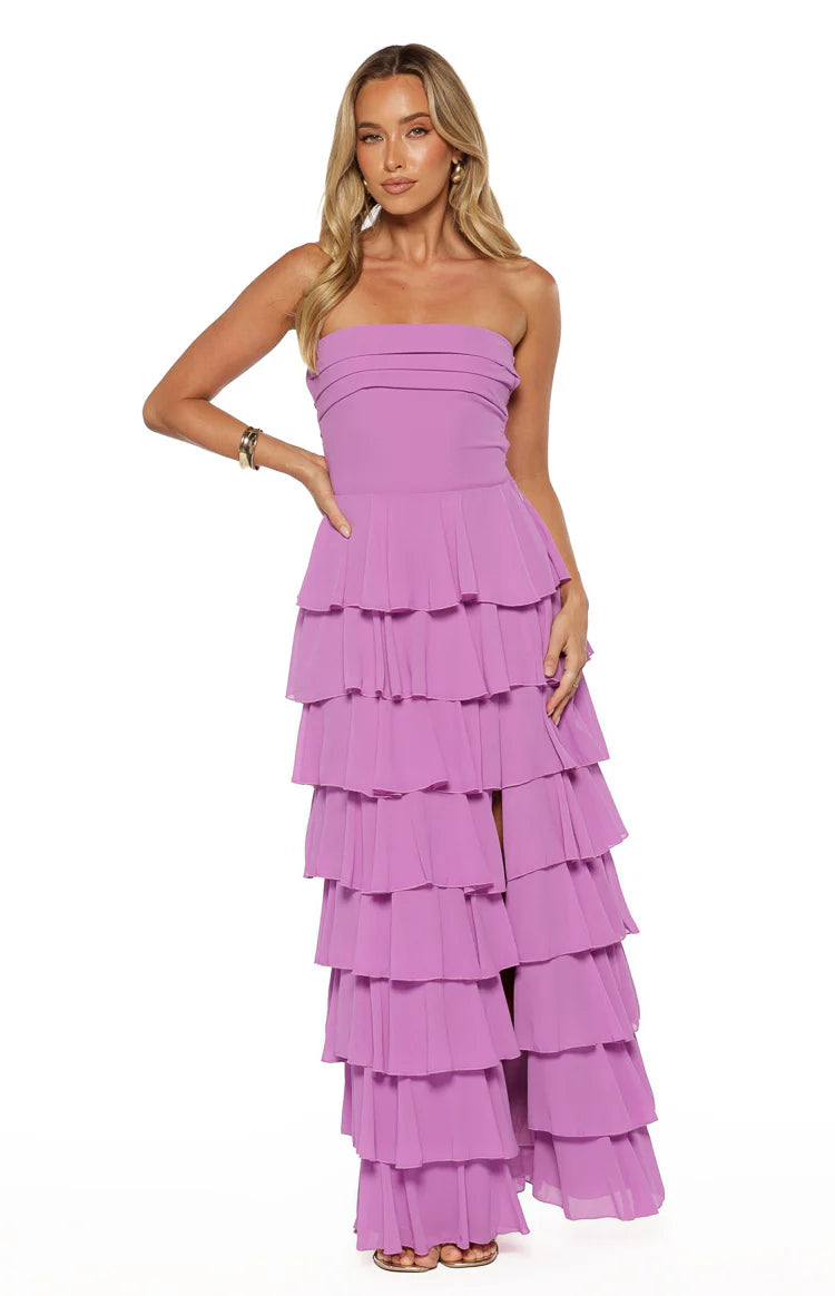 Magenta strapless maxi dress with a pleated bodice, full tiered ruffles, and a high leg split