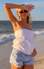 Light wash denim shorts with rolled cuffs and subtle distressed details on the front