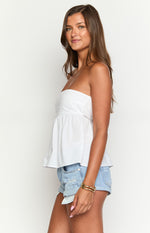 Side view of a white strapless top with a fitted bodice and a gathered peplum hem