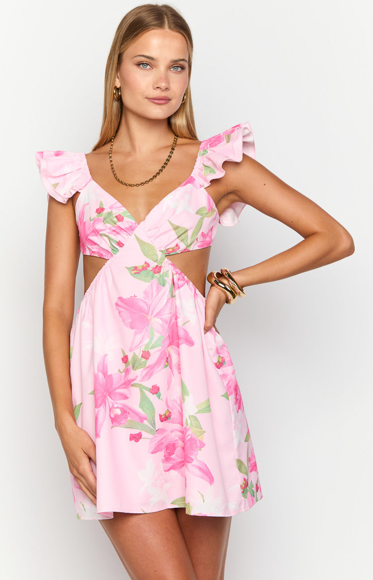 Close-up front view of the pink lilly print mini dress with V-neck, ruffled cap sleeves, and waist cutouts