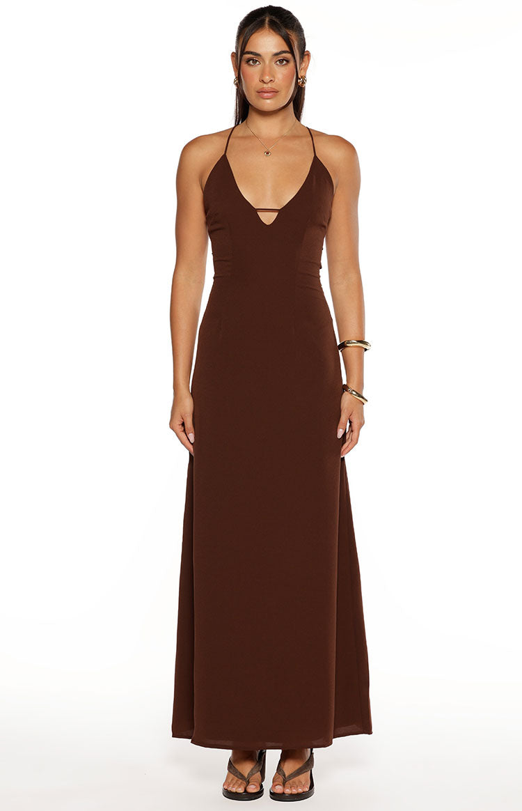 Side view of a brown maxi dress with spaghetti straps and multiple cutouts on the side of the bodice