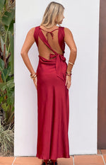Rear view of a wine satin maxi dress featuring a deep open back, thin neck tie, and wide waist tie
