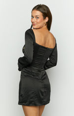 Rear view of a black satin long sleeve mini dress with a square back neckline, invisible zipper, and ruched bodice