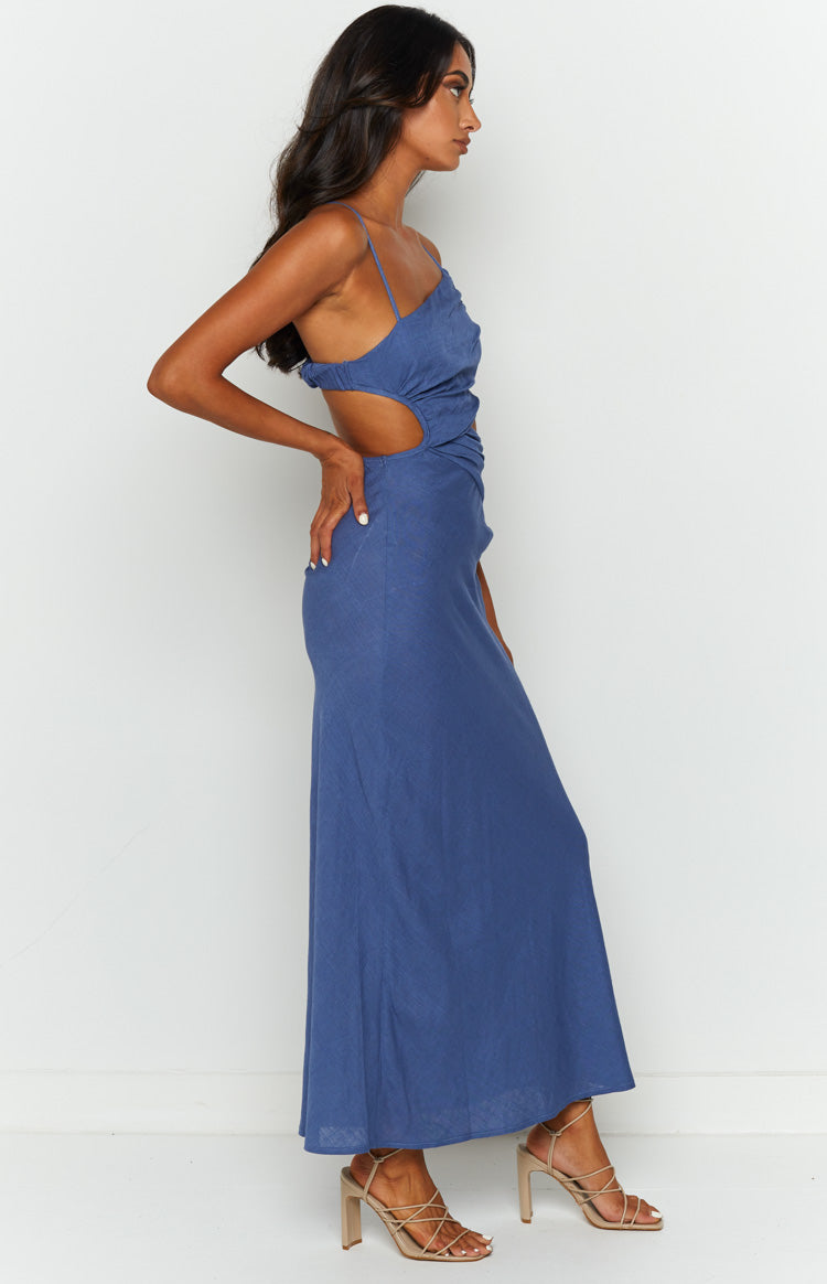 Side view of a blue maxi dress with waist cutouts and ruched detailing on the bodice