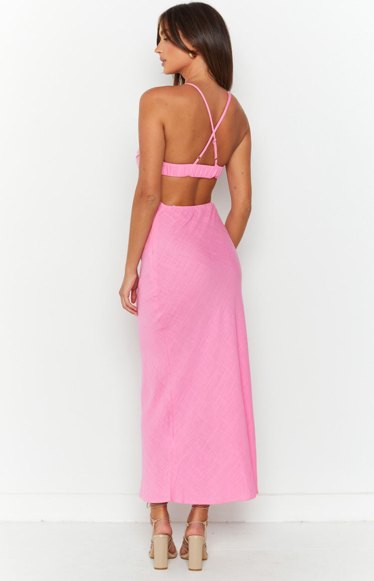 Close-up of the pink maxi dress showing the ruched side cutout detail and textured fabric