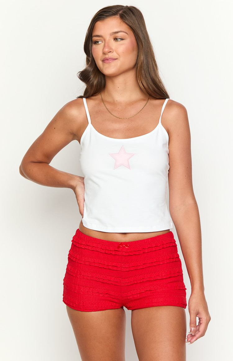 Front view of red micro shorts with tiered ruffles and a small red bow at the waist