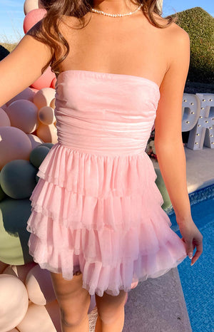 Lower front view of the pink mini dress with a ruched strapless bodice and a voluminous three-tiered tulle skirt