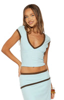 Beginning Boutique Levi Blue Contrast Bind Jersey Top light blue jersey V-neck top with short sleeves and brown contrast bind