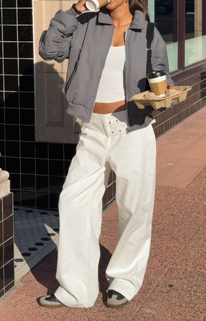 A close-up of wide-leg white pants