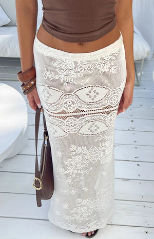 Close-up of the white crochet lace maxi skirt showing intricate floral and geometric patterns with sheer sections