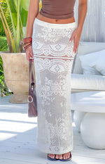 White crochet lace maxi skirt with intricate floral and geometric patterns and a sheer mid-thigh band