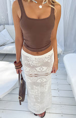 White crochet lace maxi skirt with intricate floral and geometric patterns and a sheer finish