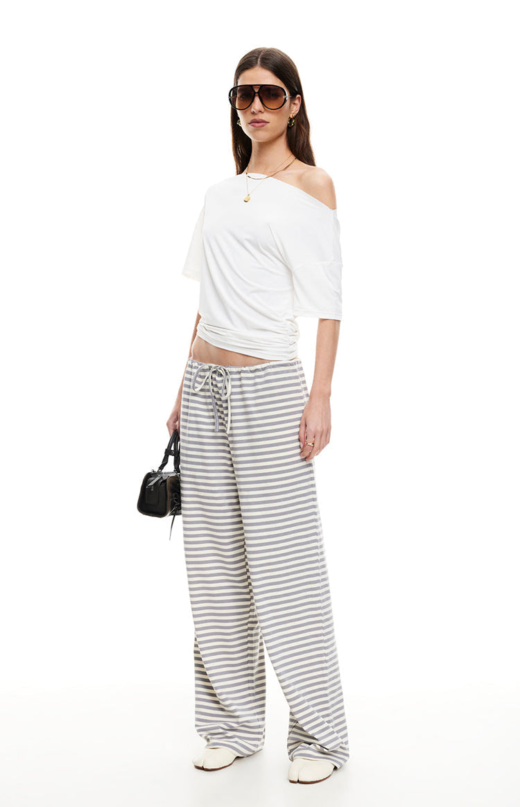Front view of ash grey and white striped wide-leg pants with a relaxed fit and drawstring waist