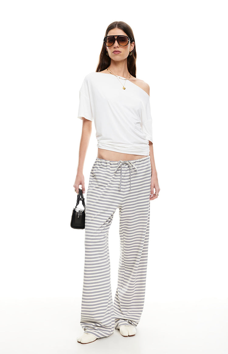 Full length view of ash grey and white striped wide-leg pants with a drawstring waist