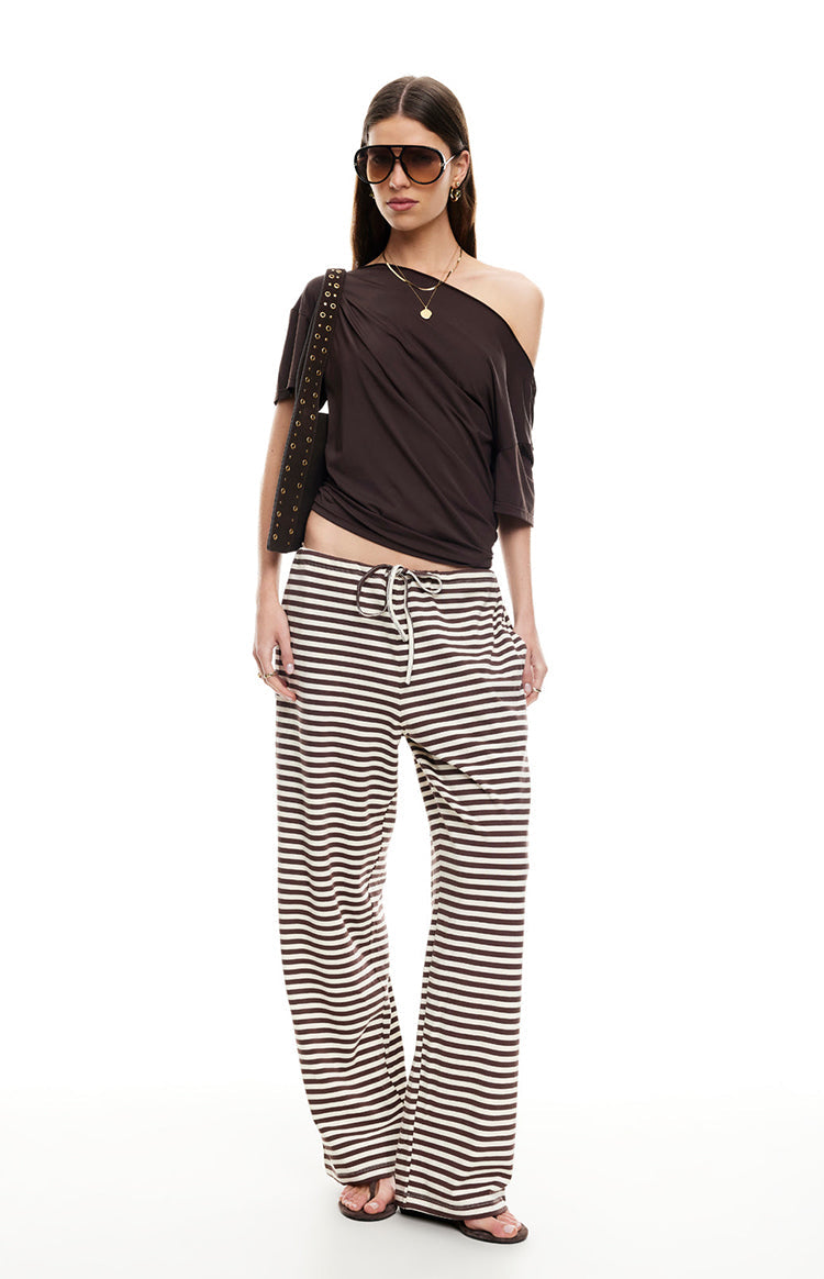 Full length view of dark chocolate and off-white striped wide-leg pants with a drawstring waist