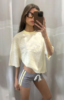 Girl taking a mirror selfie in a yellow and white striped oversized crop top a cute casual top for Summer