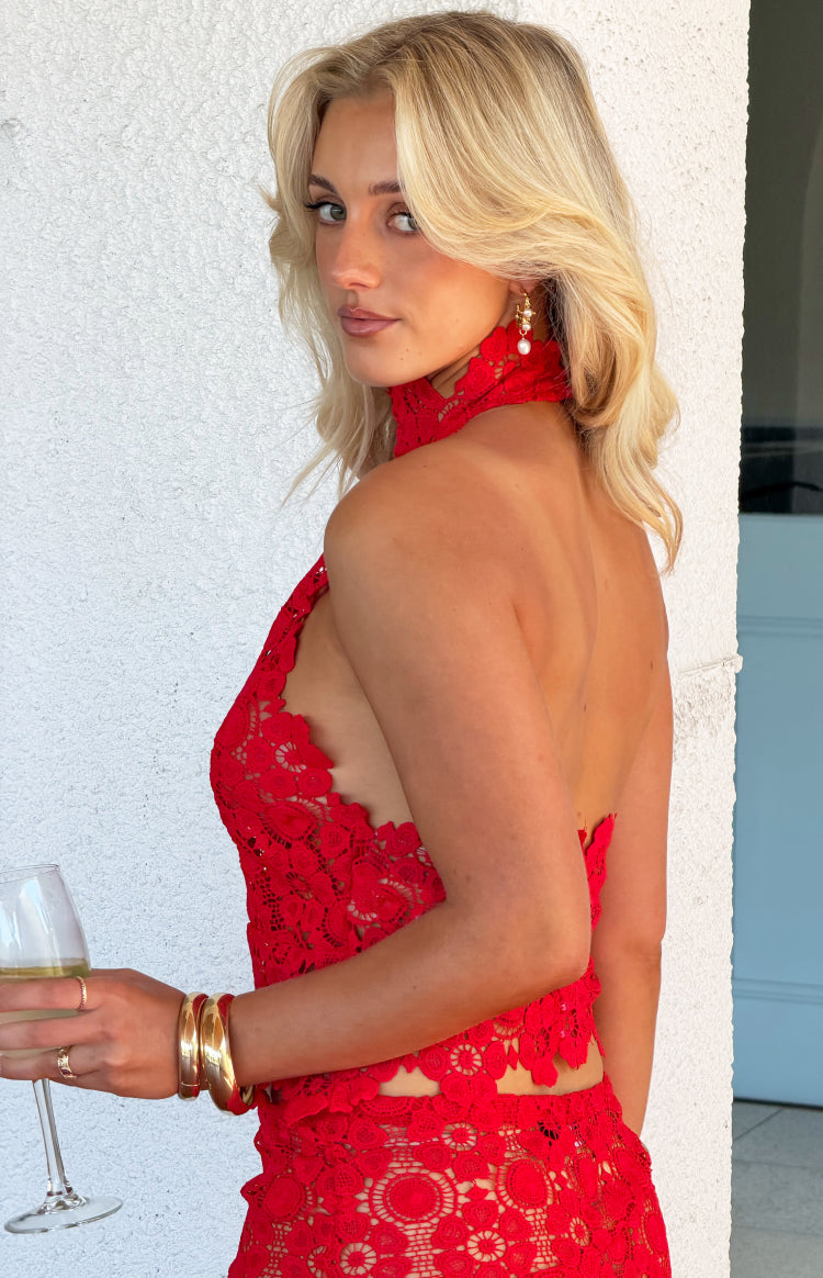 Side view of a red crochet halter top with a high choker neck and open back detail