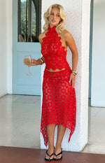 Full length view of a rouge crochet midi skirt with an intricate pattern and an asymmetrical handkerchief hem