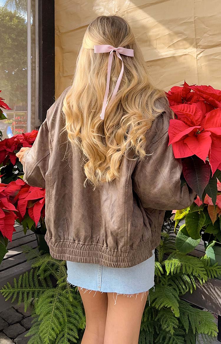 Close-up of the distressed chocolate faux leather bomber jacket with gathered sleeves and ribbed hem