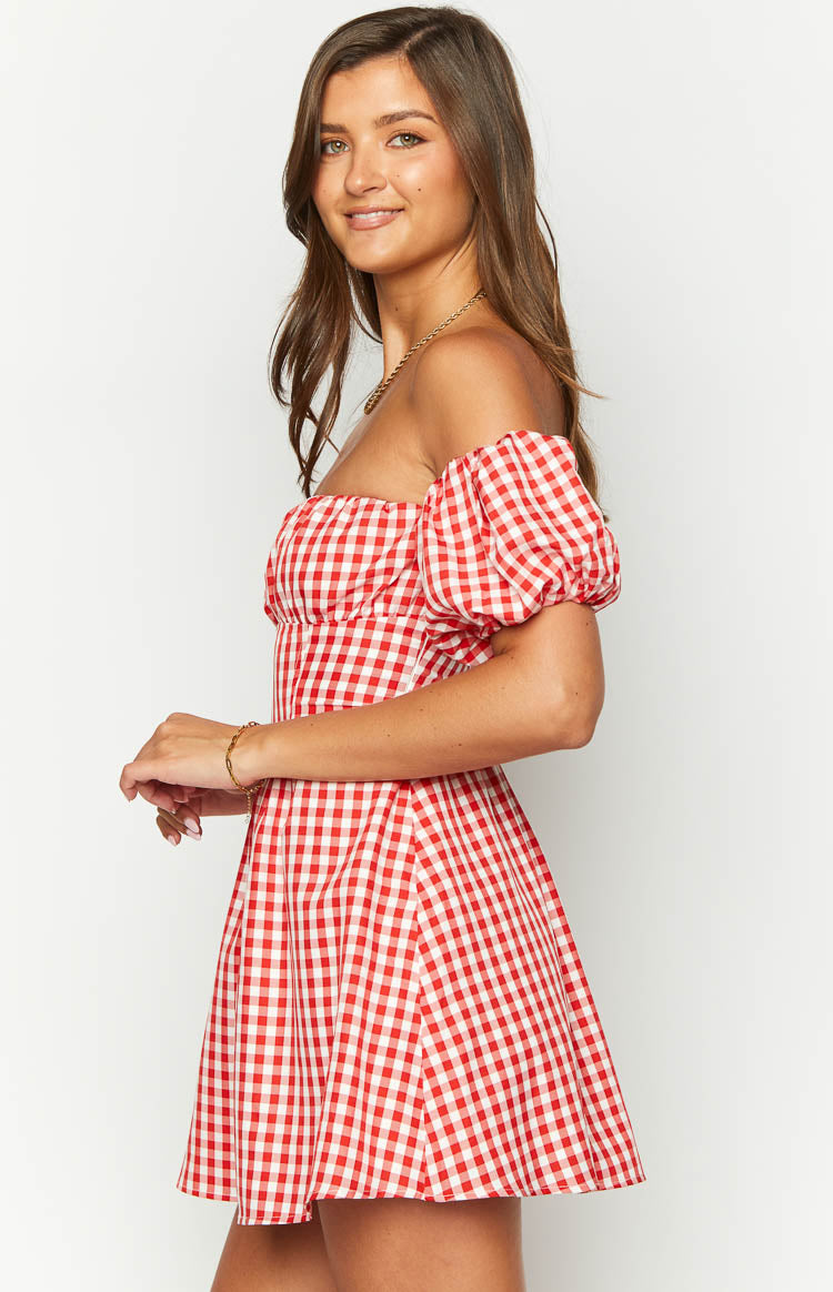 Side view of a red gingham off-shoulder mini dress with puff sleeves and a gathered bodice