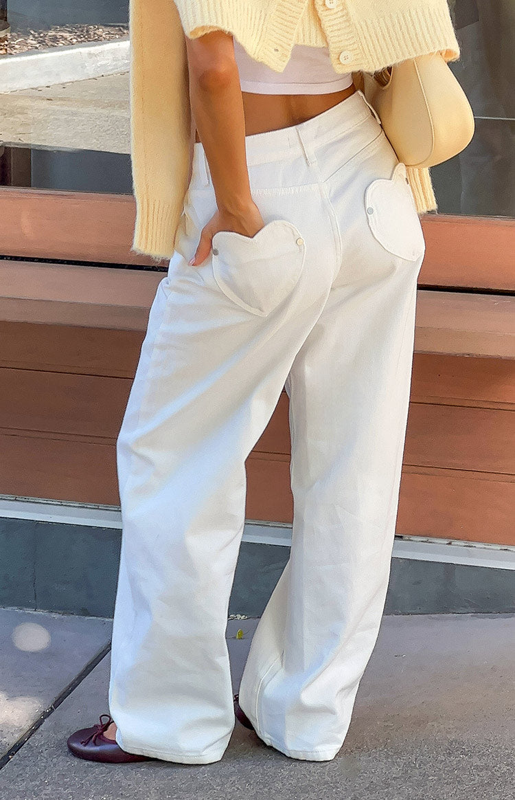 Beginning Boutique Lovers Lane White Denim Heart Pocket Slouchy Jeans white denim slouchy wide-leg jeans with heart back pock