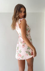 Side view of a light pink floral chiffon mini dress with ruffled cap sleeves and bodice detail