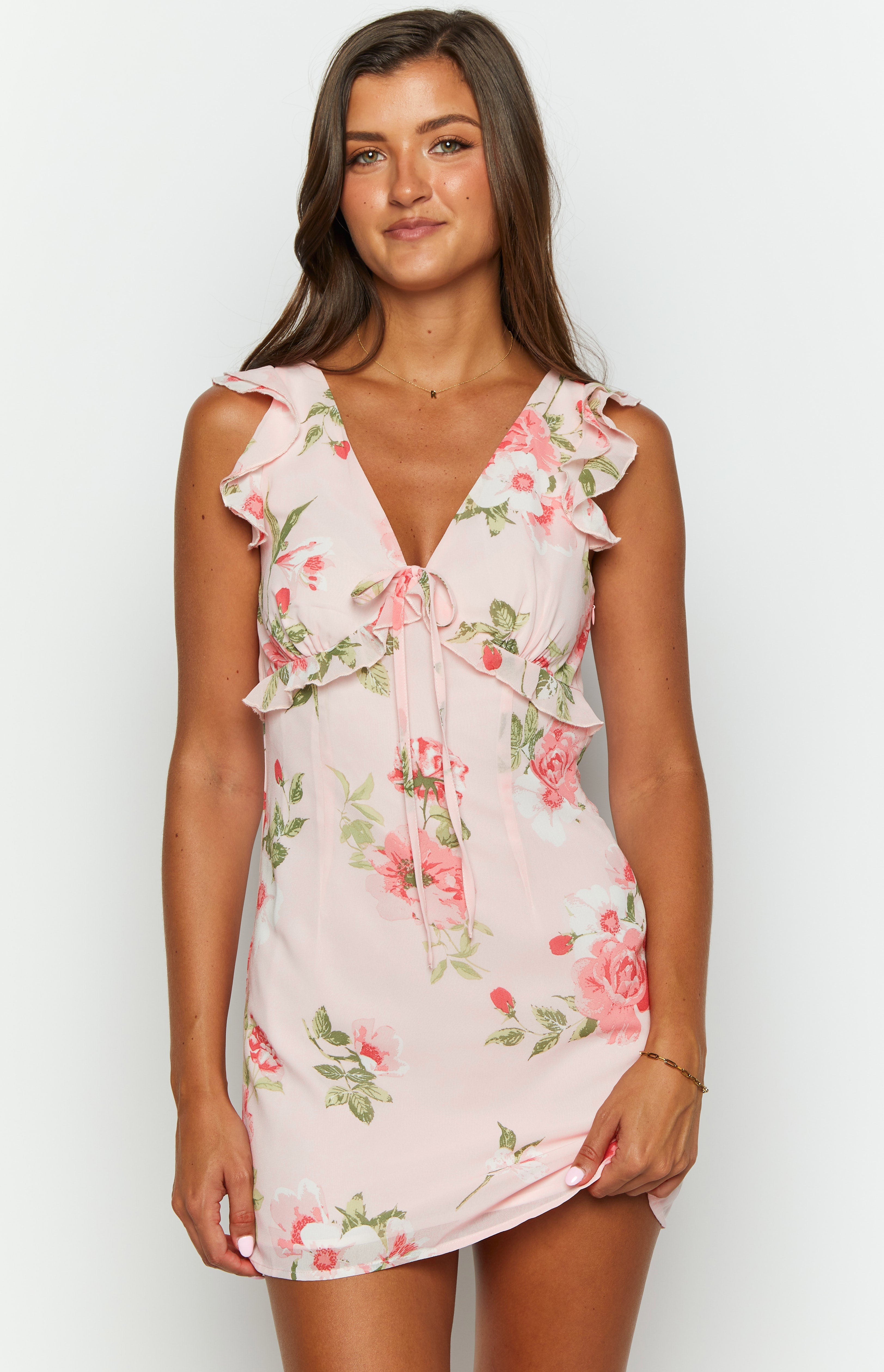 Close-up of the V-neckline with tie-front detail and ruffled shoulder straps on a pink floral chiffon mini dress