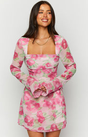 Square neckline and ruched bodice detail of a pink floral long sleeve mini dress with flared cuffs