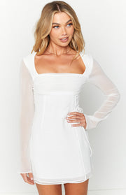 White long sleeve mini dress with a square neckline, ruched bust, and adjustable side drawstring