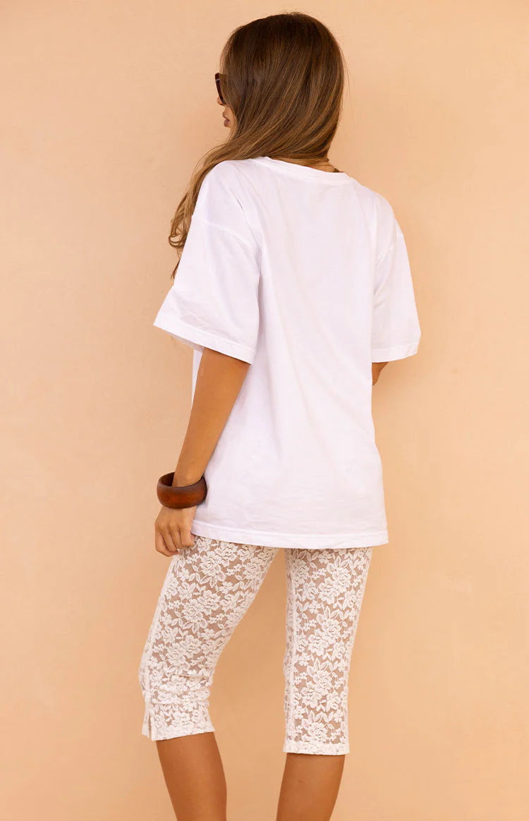 White short sleeve crew neck tee in a relaxed fit, showing the loose drape and straight hem