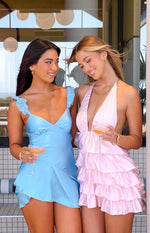 Pink satin halter neck mini dress with deep V-neck and tiered ruffled skirt