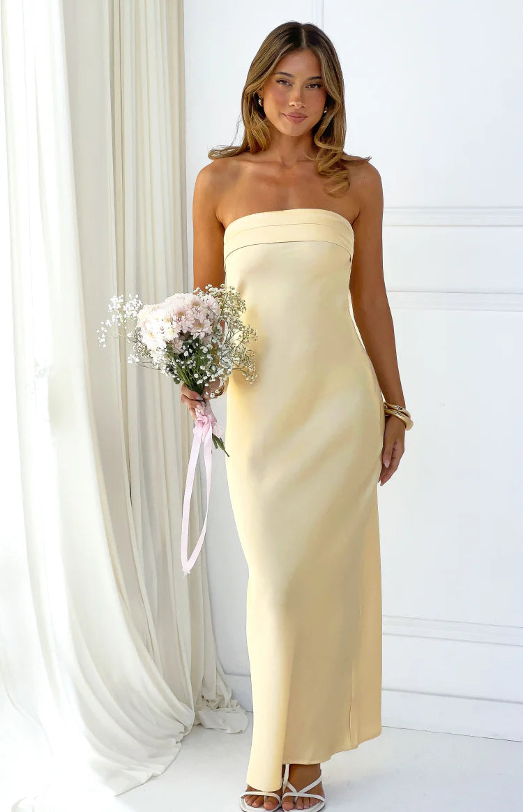 Front view of a yellow strapless maxi dress with a banded neckline and a straight, fitted silhouette