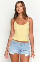 Beginning Boutique Mallorie Yellow Beaded Top yellow scoop neck cami top with thin spaghetti straps and white beaded floral patterns