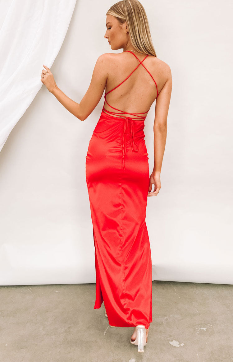 Rear view of a cherry red satin maxi dress with criss-cross back straps and a tie detail at the low back