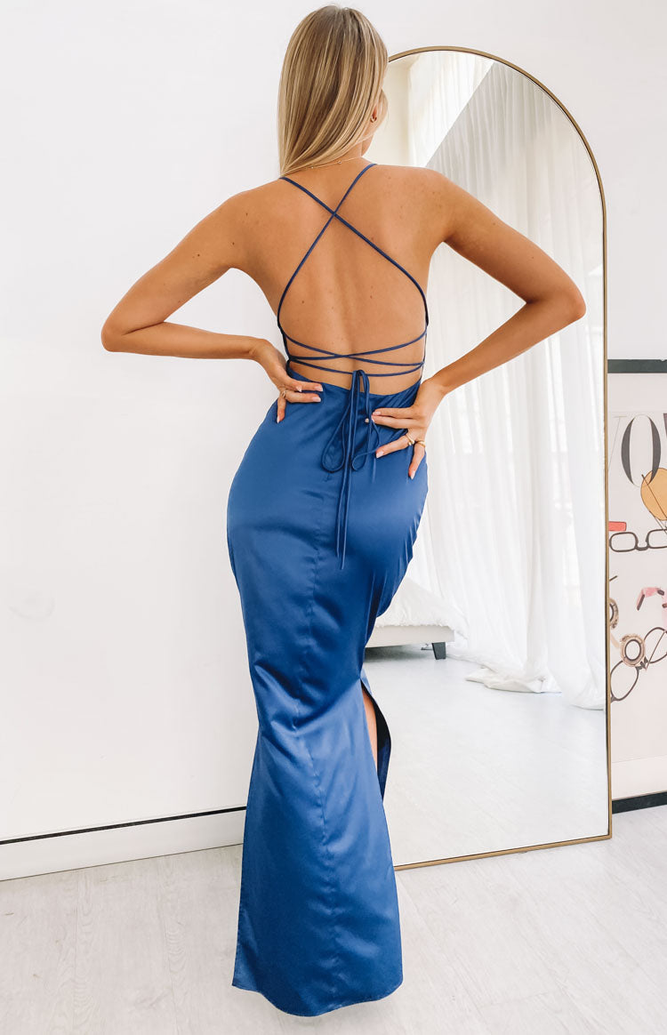 Navy satin maxi dress with cowl neckline, thin halter straps, side cutouts, and ruched detailing