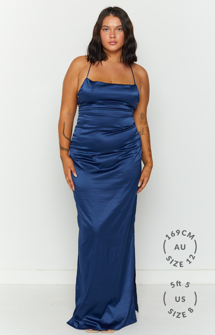 Navy satin maxi dress featuring a straight neckline, delicate spaghetti straps, and a side leg slit