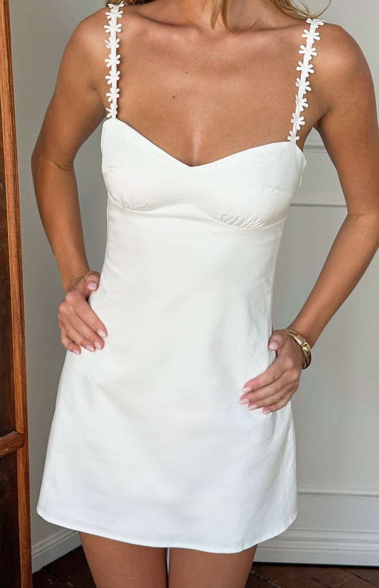 White mini dress with a sweetheart neckline and delicate daisy lace straps