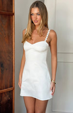 Angled front view of a white mini dress with a sweetheart neckline, fitted bodice, and daisy chain spaghetti straps